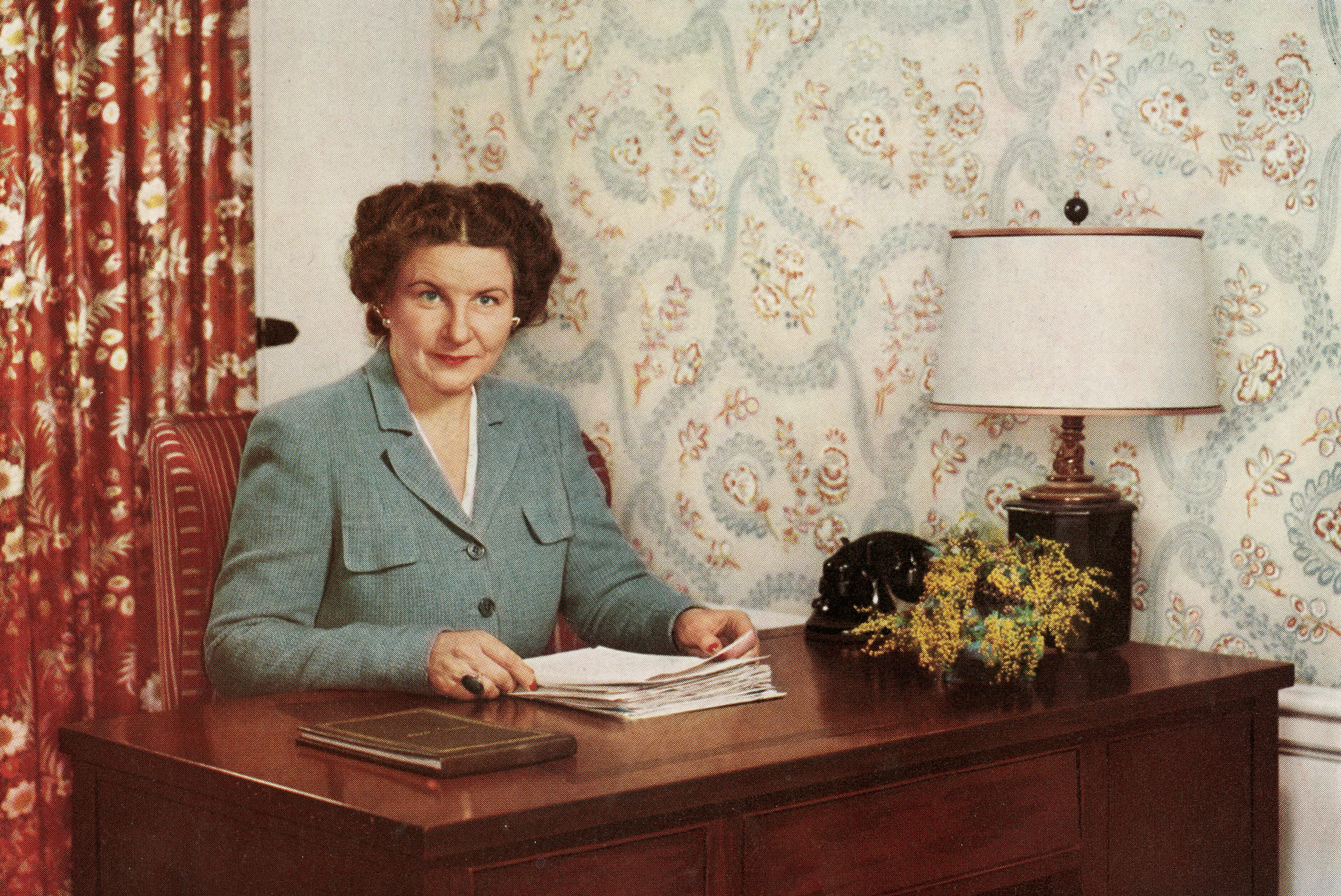 Marjorie Child Husted sitting at a desk in the 1940s