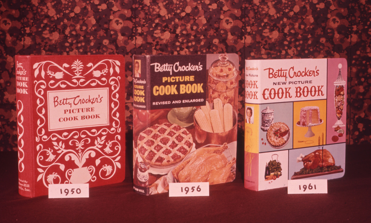 Three Betty Crocker picture cookbooks through the years